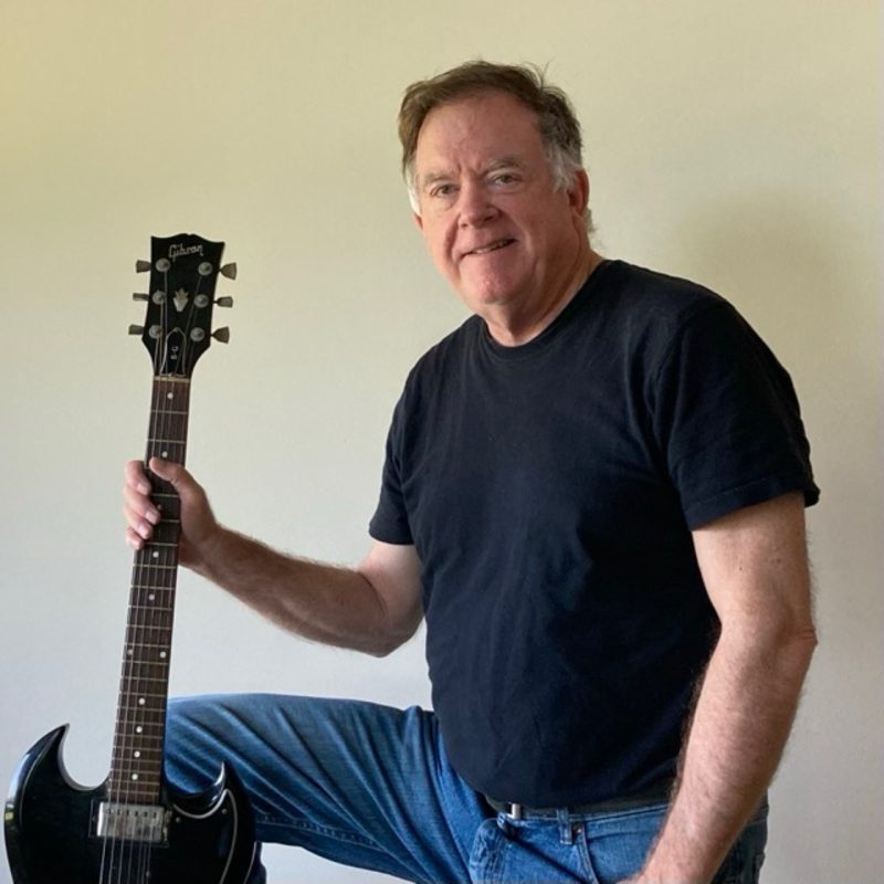 Lex Ventura of Lex & Hood holding a black Gibson SG guitar